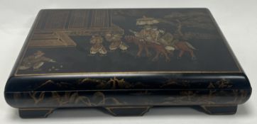 A modern Chinese black lacquer box featuring hand-painted landscape scenes and figural scene to top,