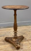 An early 20th century pine side table, circular top raised on turned column and tripartite