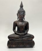 A Thai wooden hand-carved Buddha, raised on a carved base of crescent form (h. 46cm)
