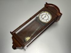 A Comitti of London 20thc Vienna style burr walnut chiming wall clock with moulded top and full