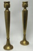 A pair of Emily Readett-Bayley limited London giltwood candlesticks of faceted form, raised on