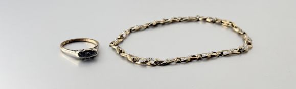 A 9ct gold figure of eight link bracelet set five diamond points with lobster claw fastening: d. x