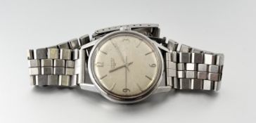 A vintage Longines stainless steel manual wind wristwatch with silvered dial and roman numerals at