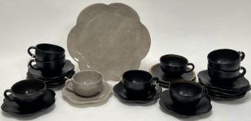 A mixed collection of Maryse Boxer tea service ware in mottled tan, black, and gilt, each with