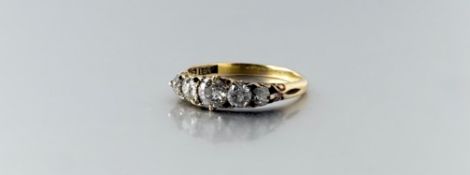 An 18ct gold ring set five old mine cut graduated diamonds largest approximately 0.25ct set two