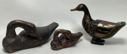 A graduated pair of wooden carved red and gilt painted duck figurines (largest l. 37cm), together