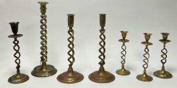 A collection of 19th and 20thc brass barley twist candlesticks, each raised on circular bases, two