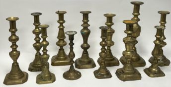 A collection of late 19th and 20thc assorted brass candlesticks, comprising examples with knopped
