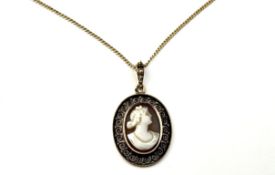 A yellow metal mounted filligree open work pendant with shell carved portrait cameo: l. x 2cm on