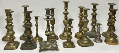 A collection of late 19th and 20thc assorted brass candlesticks, comprising a pair of knopped stem