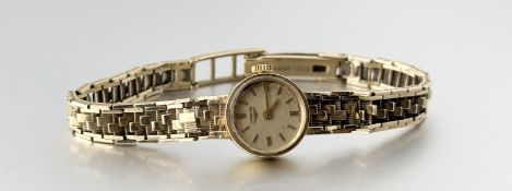 A vintage 9ct gold Longines manual wind wristwatch with a champagne dial and baton hour markers on
