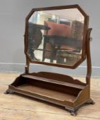 A Victorian mahogany swing mirror, octagonal plate raised on shaped supports, two-tier platform base