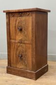 A 19th century flame mahogany bedside cabinet, with two cupboard doors to front raised on a plinth