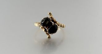 A 18k gold ring set with a pair of grey star sapphires each stone approximately 0.22ct O 2.95g