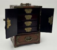 A 20thc Chinese hardwood jewellery cabinet with carved and pierced jade panels, brass fittings