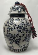 A large decorative India Jane of London blue & white lidded urn of bulbous form, with blossom