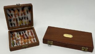 Fishing Interest: A Richard Wheatley teak fly box containing two levels of flies (l. 25.5cm),