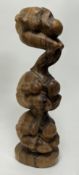 A lightwood Indonesian carved figure group of the Weeping Buddha ascending, raised on a carved