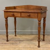 A Victorian mahogany writing table, shaped ledge back over two frieze drawers, raised on tapered
