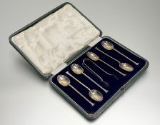 A George V Sheffield silver set of six seal handled tea spoons: l. x 11cm and pair of cubed sugar