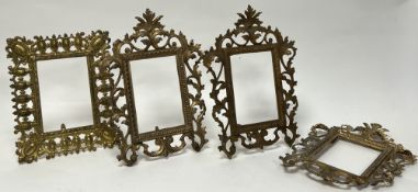 A collection of four ornate cast metal frames, with openwork design in the rococo revival taste with