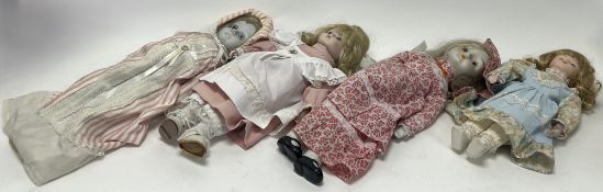 A collection of four modern bisque headed dolls, dressed in the Victorian style, three with inset