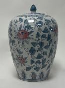 A 20thc Chinese ginger jar of bulbous form, with green foliate decoration and pink chrysanthemums (