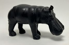 A 20thc leather-covered ornamental model of a standing hippopotamus with glass eyes, in the style of