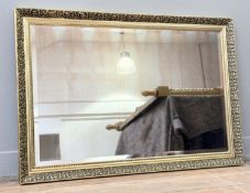 A gilt gesso cushion frame with a bevelled mirror panel. (66cmx97cm)