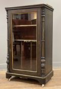 A Victorian Aesthetic Movement music cabinet, ebonised with pierced brass ledge top over glazed