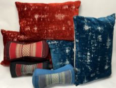 A collection of three Thai handmade Kapok neck pillows, with embroidered central panels, in black,