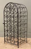 A wrought iron wine rack, arched scrollwork panel front opening to reveal capacity for 35 bottles: