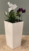 A large modern planter with faux-plants, of square tapered form with artificial orchids and