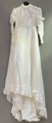 A vintage Edwardian-style white lace wedding dress with a high neckline and delicate lace trim,