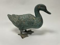 A patinated cast metal standing duck figure with verdigris style finish (h. 25cm)