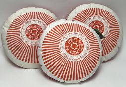 A Nikki McWilliams cotton rectangular Tunnock's Teacake pillow, decorated in ivory and red with