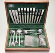 A Viners Studio mid century teak canteen containing a suite of stylish stainless steel panished