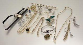 A collection of costume jewellery to include a paste pearl green panel spray brooch, a gilt metal