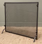 A large modern wrought iron fire screen, metal mesh with twin handles to top and raised on bracket