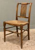 An Edwardian ash and elm side chair, spindle back with woven rush seat, raised on turned supports