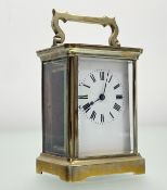 A brass four glass clock with enamel dial amnd roman numerals with key: h. x 11cm l. x 7.7cm w. x
