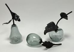 A collection of green studio glass fruits with bronzed metal stems, comprising an apple, a pear, and