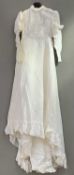 A vintage Edwardian-style white lace wedding dress with a high neckline and delicate lace trim,