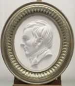 A circular moulded plaster plaque of Robert Burns, mounted in a wooden frame. (53cmx47cm)