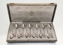 A Durch white metal set of twelve pierced tea spoons: l. x 11cm in original satin an dove grey