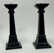 A pair of black ebonised wooden candlesticks on stepped bases (h. 32cm) (2)
