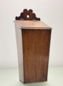 A 19thc Mahogany wall hanging candle box, with sloping hinged cover, with carved top. (h-42cm)