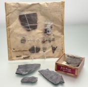 A collection of various artifacts fragments, all with hand-written notes, each item attached on