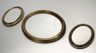 A collection of two (21cmx16cm) plus one larger (28cmx34cm) circular gilt framed mirrors. (3)