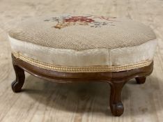 A Victorian mahogany footstool, needlework cushion top on oval base, raised on cabriole supports: H.